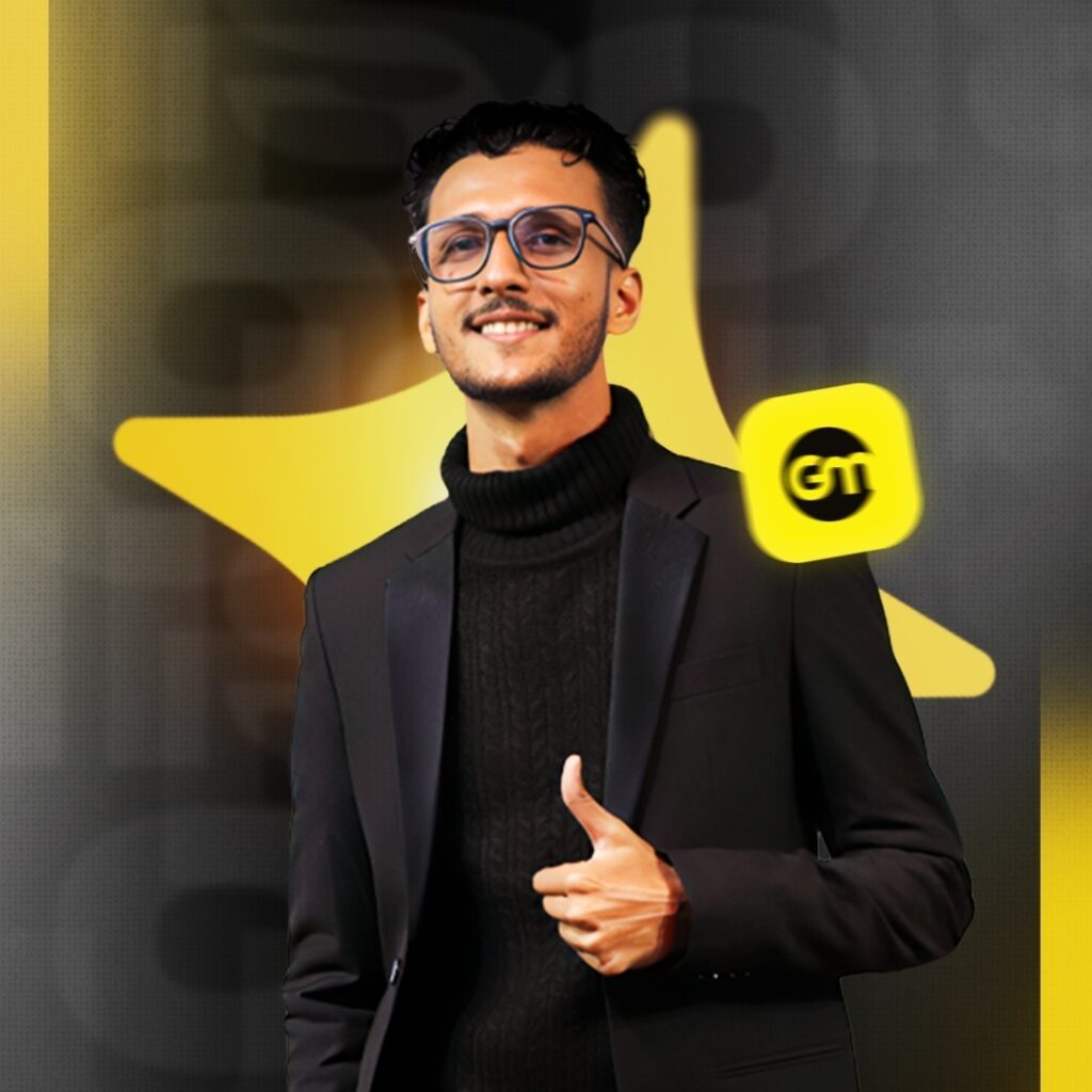 Professional headshot of Joydip Kirtunia, founder of our white label SEO agency, smiling confidently in a black turtleneck sweater and blazer, giving a thumbs-up gesture, with a golden star background and GTM logo overlay.